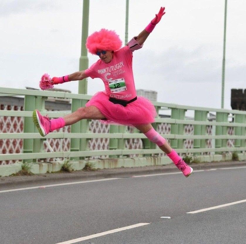 David mid-leap in a full pink tutu on race day